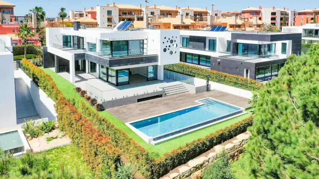 an aerial view of a house with a swimming pool